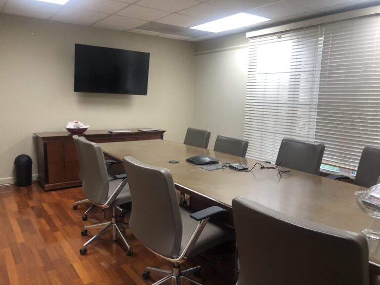 Conference room with meeting table and wall-mounted television at Nuvork